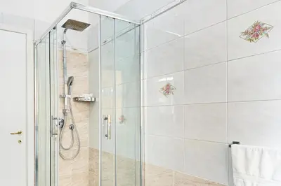a shower with a glass door in a bathroom at Roma Passion Suite in Rome