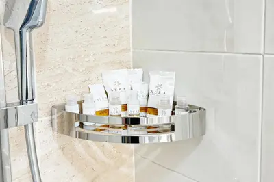 a shelf with bottles of essential oils in a bathroom at Roma Passion Suite in Rome