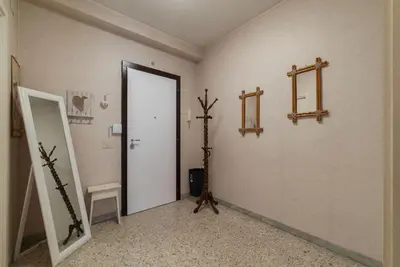 a hallway with a door and a mirror on a wall at GuestHost - La Rosa di Trastevere in Rome