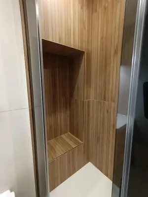 a walk in shower with a wooden wall at World Wide Bed Termini in Rome