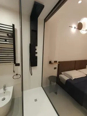 a small bathroom with a bed and a sink at World Wide Bed Termini in Rome