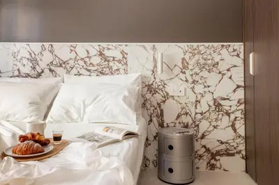 a bed with a plate of food on a tray on it at Interno2 - Cozy flat near Vatican Museums in Rome