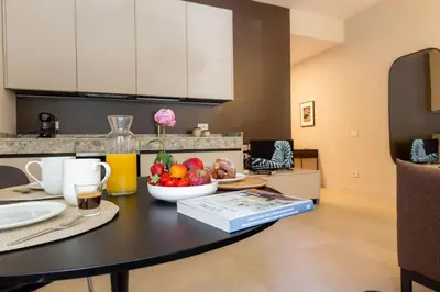 a table with a bowl of fruit on it in a kitchen at Interno2 - Cozy flat near Vatican Museums in Rome