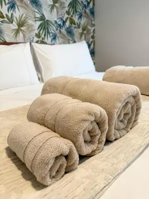 a pile of towels sitting on top of a bed at Borgo Una Casa Nel Vicolo in Rome