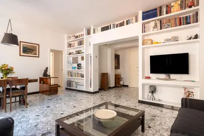 a living room with a couch and a tv at Bright and spacious flat in the hearth of Rome in Rome