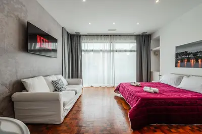 a living room with a bed and a couch at Rome Centre - Spacious Apartment - Jacuzzi - AC - WiFi in Rome