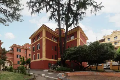 a building with a tree in front of it at GuestHost - Cozy Apartment near Tiburtina in Rome
