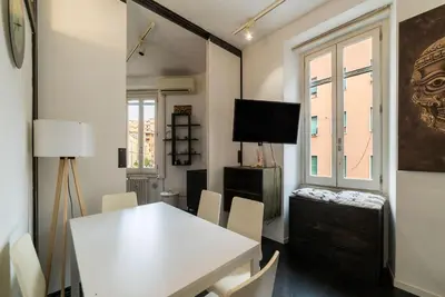 a dining room with a white table and chairs at GuestHost - Cozy Apartment near Tiburtina in Rome
