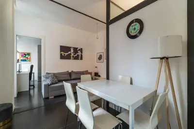 a living room with a white table and chairs at GuestHost - Cozy Apartment near Tiburtina in Rome