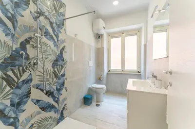 a bathroom with a toilet and a sink at Jhonny's Apartment Near Vatican 3 bedroom's in Rome