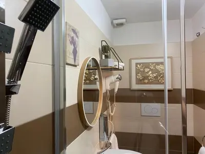 a bathroom with a mirror and a sink at Guest house Aria in Rome