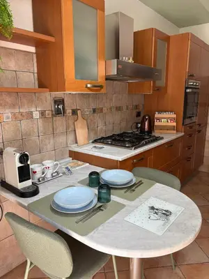 a kitchen with a table with plates on it at San Pietro Street 9 in Rome