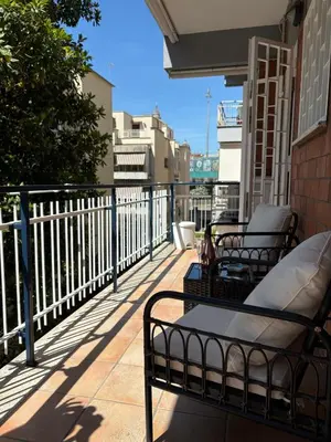 a patio with two chairs and a table on a balcony at San Pietro Street 9 in Rome