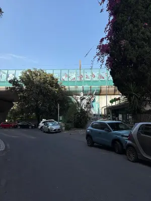 a street with cars parked on the side of a road at San Pietro Street 9 in Rome
