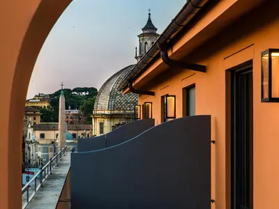 a view of the city from a balcony of a building at Rarity Suites in Rome
