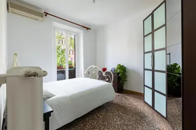 a bedroom with a white bed and a window at La Casa di Edo in Rome