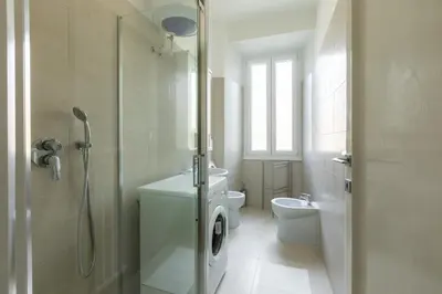 a white bathroom with a shower and a toilet at La Casa di Edo in Rome
