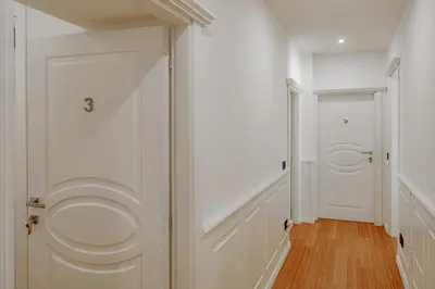 a white bathroom with a toilet in a hallway at Historical Center in Rome