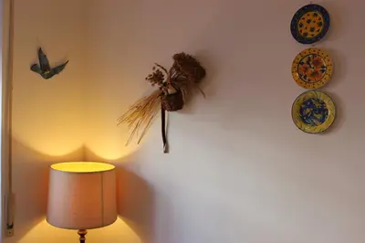a room with a lamp and plates on a wall at casa vacanze Borgo San Lazzaro in Rome