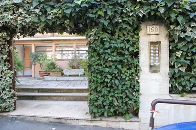 a building with a ivy growing on the side of it at casa vacanze Borgo San Lazzaro in Rome