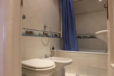 a bathroom with a toilet and a sink and a tub at casa vacanze Borgo San Lazzaro in Rome