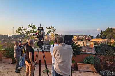 a group of people standing on a balcony with a camera at San Pietro in Vaticano Terrazza Giovy in Rome
