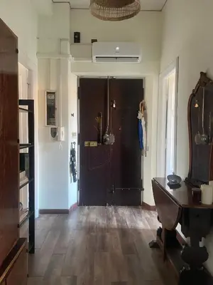 a person taking a picture of a door in a room at Sunny apartment in central Rome in Rome