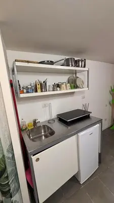 a small kitchen with a sink and a counter at la casa di lola in Rome