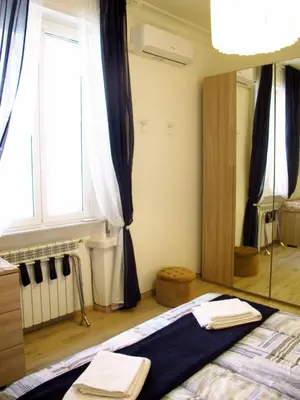 a bedroom with a bed and a large mirror at Blue House Termini-Colosseo in Rome