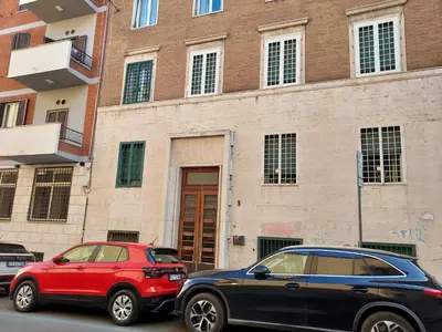 two cars parked in front of a building at Blue House Termini-Colosseo in Rome
