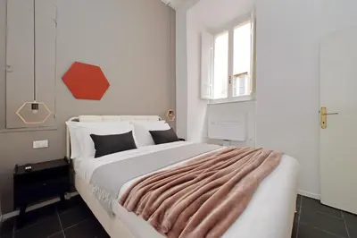 a bedroom with a large bed with a blanket on it at Pantheon Authentic and Modern Apartment in Rome