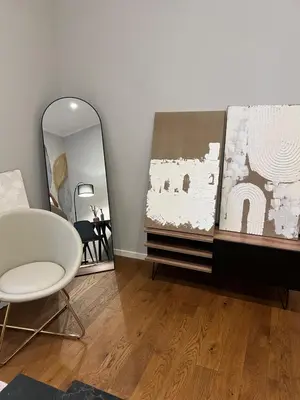 a living room with a mirror and a chair at Archouse - Elegant apartment a 10 min dal Colosseo in Rome