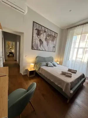 a bedroom with a large bed in a room at Archouse - Elegant apartment a 10 min dal Colosseo in Rome