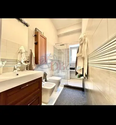 a bathroom with a toilet and a sink and a shower at Archouse - Elegant apartment a 10 min dal Colosseo in Rome