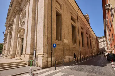 a large brick building with a person walking past it at Navona Maison in Rome