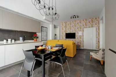 a kitchen and a living room with a table and chairs at Modern house near Trastevere in Rome