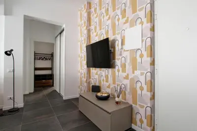 a living room with a tv on a wall at Modern house near Trastevere in Rome