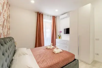 a bedroom with a large bed with blue curtains at Stylish Vatican Stay - WiFi Metro Walk Everywhere in Rome