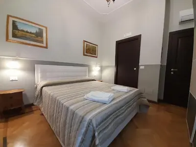 a bedroom with a bed with two towels on it at Il Sole di Roma in Rome