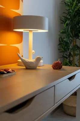 a table with a lamp and a bowl on it at Cornelia Vatican Suites in Rome