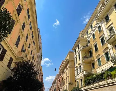 two tall buildings next to each other on a street at MARIA TERESA Apartment II - Refined Living with Excellent City Links - Via Alessandria - QUARTIERE TRIESTE in Rome