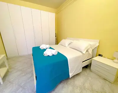 a bedroom with a bed with towels on a table at MARIA TERESA Apartment II - Refined Living with Excellent City Links - Via Alessandria - QUARTIERE TRIESTE in Rome