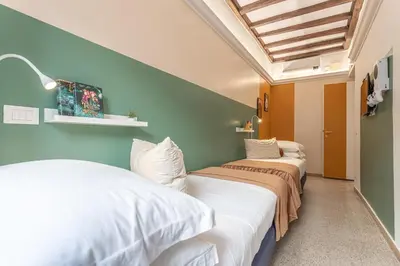 two beds in a room with green walls at Key Apartment Trastevere in Rome