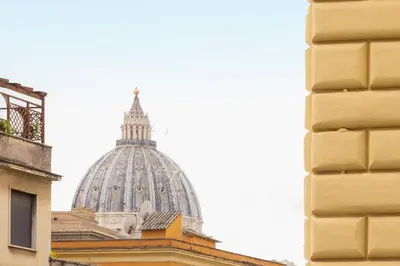 a building with a dome in the background at Cola di Rienzo Apartment by Rental in Rome in Rome