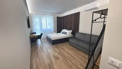 a living room with a couch and a bed at Luxury AV Vaticano in Rome