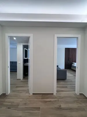 a hallway with white walls and a living room at Luxury AV Vaticano in Rome