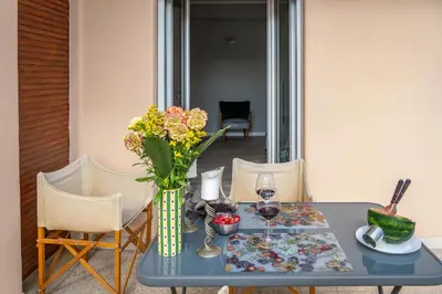 a table with a vase of flowers and wine glasses at 18 Vatican Penthouse in Rome