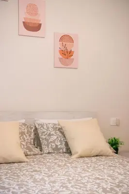 a white bedroom with a bed with pillows at MaSa Holidays House Vatican in Rome
