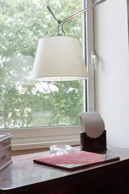 a lamp sitting on a table next to a window at Sant'Angelo Apartment in Rome