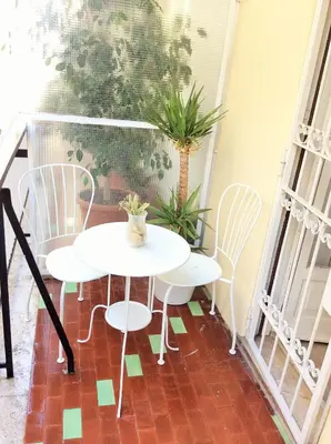 a white table and chairs on a balcony at Big Home In Vatican in Rome